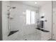 Shower with glass enclosure, rainfall showerhead, and modern tile at 8048 Grady Cir, Castle Rock, CO 80108