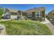 Lush backyard featuring a well-maintained lawn, stone pathway, and covered porch at 15347 Quince Cir, Thornton, CO 80602
