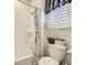 Cozy bathroom featuring a shower-tub combo with floral shower curtain and window with white blinds at 15347 Quince Cir, Thornton, CO 80602