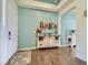 Inviting foyer features hardwood floors, a white door, and decorative accents at 15347 Quince Cir, Thornton, CO 80602