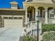 Inviting home exterior with a stone-accented garage and a cozy, covered front porch entrance at 15347 Quince Cir, Thornton, CO 80602