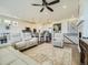 Spacious living room boasts hardwood floors, a ceiling fan, and an open floor plan with the kitchen at 15347 Quince Cir, Thornton, CO 80602