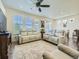 Bright living room with large windows, comfortable sofas, and an area rug at 15347 Quince Cir, Thornton, CO 80602