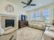 Cozy living room featuring a fireplace, large windows, and comfortable seating at 15347 Quince Cir, Thornton, CO 80602