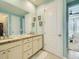 Well-lit bathroom with double sinks, granite countertops, and access to the main bedroom at 15347 Quince Cir, Thornton, CO 80602