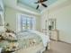 Bright main bedroom with shuttered bay windows, tray ceilings, and a decorative four-poster bed at 15347 Quince Cir, Thornton, CO 80602