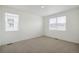 Bright bedroom with neutral carpet, two windows for natural light, and blank canvas for decor at 862 Crest St, Lochbuie, CO 80603