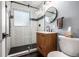 Modern bathroom with subway tile, a sleek vanity, and a glass shower at 3200 S Grape St, Denver, CO 80222