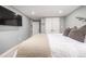 Basement bedroom with a large bed, neutral decor and a view of another room at 3200 S Grape St, Denver, CO 80222