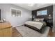 Cozy bedroom with a dark accent wall and wood floors at 3200 S Grape St, Denver, CO 80222