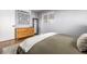 Bedroom with dresser, mirror, and neutral-toned bedding at 3200 S Grape St, Denver, CO 80222