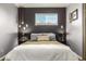 Bedroom with a dark accent wall, wood floors, and a window with blinds at 3200 S Grape St, Denver, CO 80222