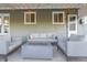 Covered patio with seating area and fire pit, perfect for outdoor entertaining at 3200 S Grape St, Denver, CO 80222