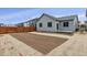 Exterior of home displaying backyard with a partial fence, landscaping, and patio at 1464 Orchard St, Brighton, CO 80601