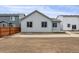 Exterior of home displaying backyard with a partial fence and landscaping possibilities at 1464 Orchard St, Brighton, CO 80601