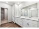Bathroom with double sink vanity, large mirror, and modern fixtures at 1464 Orchard St, Brighton, CO 80601