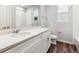Bathroom featuring white cabinets, modern fixtures, and hardwood floors at 1464 Orchard St, Brighton, CO 80601