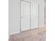 Bedroom closet with white sliding doors and neutral carpet flooring at 1464 Orchard St, Brighton, CO 80601