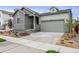 Charming home with a gray exterior, attached garage, and landscaped front yard at 1464 Orchard St, Brighton, CO 80601