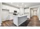 Bright kitchen featuring an island, stainless appliances, and white cabinets at 1464 Orchard St, Brighton, CO 80601