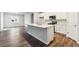 Bright kitchen features an island, stainless appliances, and white cabinets at 1464 Orchard St, Brighton, CO 80601