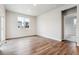 Bright, open living room featuring wood floors, large window, and neutral paint at 1464 Orchard St, Brighton, CO 80601