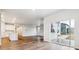 Open-concept living and kitchen area with sleek floor, white walls and lots of light at 1464 Orchard St, Brighton, CO 80601