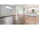 Open-concept living and kitchen area with sleek floor, white walls and lots of space at 1464 Orchard St, Brighton, CO 80601