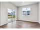 Bright living room with sleek floor, white walls and sliding glass door at 1464 Orchard St, Brighton, CO 80601