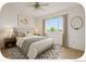 Well-staged bedroom offers ample light, neutral walls, and attractive decor at 2644 Devonshire Ct, Denver, CO 80229