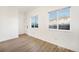 Bright bedroom featuring hardwood floors and natural light from two windows at 2644 Devonshire Ct, Denver, CO 80229