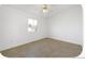 This is an empty bedroom featuring natural light from a window and a ceiling fan at 2644 Devonshire Ct, Denver, CO 80229
