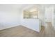 A modern dining area with an open view into the kitchen, with ample lighting and hardwood floors at 2644 Devonshire Ct, Denver, CO 80229