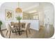 Open dining area flows into the kitchen, complemented by a stylish light fixture and decor at 2644 Devonshire Ct, Denver, CO 80229