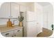 Cozy kitchen featuring gray cabinets, modern appliances, and wood-look flooring at 2644 Devonshire Ct, Denver, CO 80229