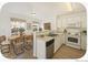 An inviting kitchen with a dining area, featuring white cabinets and modern appliances at 2644 Devonshire Ct, Denver, CO 80229