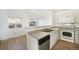 Kitchen with modern appliances, stone countertop, and seamless access to the dining area at 2644 Devonshire Ct, Denver, CO 80229