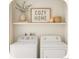 Functional laundry room with updated appliances and convenient shelving at 2644 Devonshire Ct, Denver, CO 80229