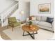 Cozy living room with stylish furnishings, bright walls, and open staircase at 2644 Devonshire Ct, Denver, CO 80229