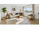 Bright living room with modern decor, fireplace, and ample natural light at 2644 Devonshire Ct, Denver, CO 80229