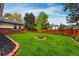 Expansive backyard with lush green grass, a wooden fence, and well-placed trees, offering serene outdoor space at 3608 S Newport Way, Denver, CO 80237