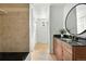 Bathroom vanity featuring dual sinks, and granite countertops at 3608 S Newport Way, Denver, CO 80237