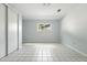 Bright bedroom with tiled floor and natural light from the window at 3608 S Newport Way, Denver, CO 80237
