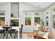Open dining room featuring hardwood floors, fireplace, and neutral decor at 3608 S Newport Way, Denver, CO 80237