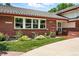 Charming brick home with manicured lawn and colorful flower beds at 3608 S Newport Way, Denver, CO 80237
