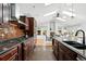 Modern kitchen featuring stainless appliances, granite counters and dining area at 3608 S Newport Way, Denver, CO 80237