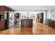 Open-concept kitchen with stainless steel appliances and hardwood flooring at 3608 S Newport Way, Denver, CO 80237