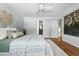 Bright main bedroom with an ensuite bathroom, hardwood floors, neutral color, and an area rug at 3608 S Newport Way, Denver, CO 80237