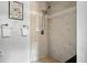 Detailed shot of tiled shower with multi-setting shower head and fixtures at 3608 S Newport Way, Denver, CO 80237