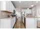 Modern kitchen with white cabinets, granite countertops and island at 18815 W 93Rd Ave, Arvada, CO 80007